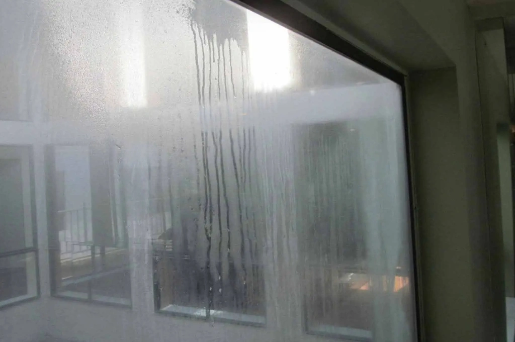 Before and after of a foggy double-glazed window repaired to crystal clear condition by RHS in Gibraltar.