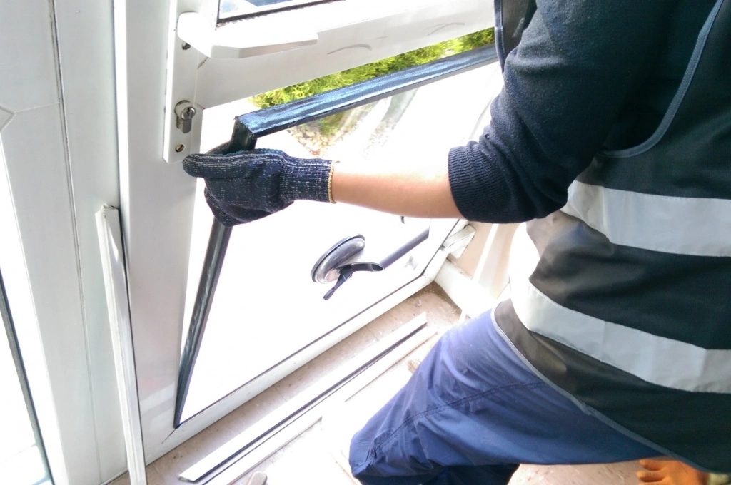 Professional RHS technician performing aluminium window repair in Gibraltar for a coastal residential property.
